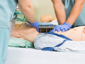 Nurse Performing CPR on Medical Training Simulator