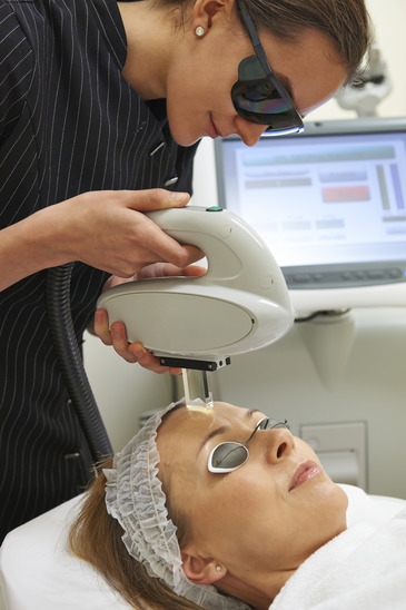 Beautician Carrying Out Fractional Laser Treatment