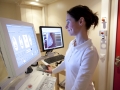 Radiology technician performs mammography test