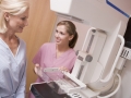 Nurse Assisting Patient About To Have A Mammogram